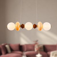 Lampa wisząca podłużna z elementami ceramiki i białymi kloszami FLORES 20W LED 3000K Candellux Studio 33-50687
